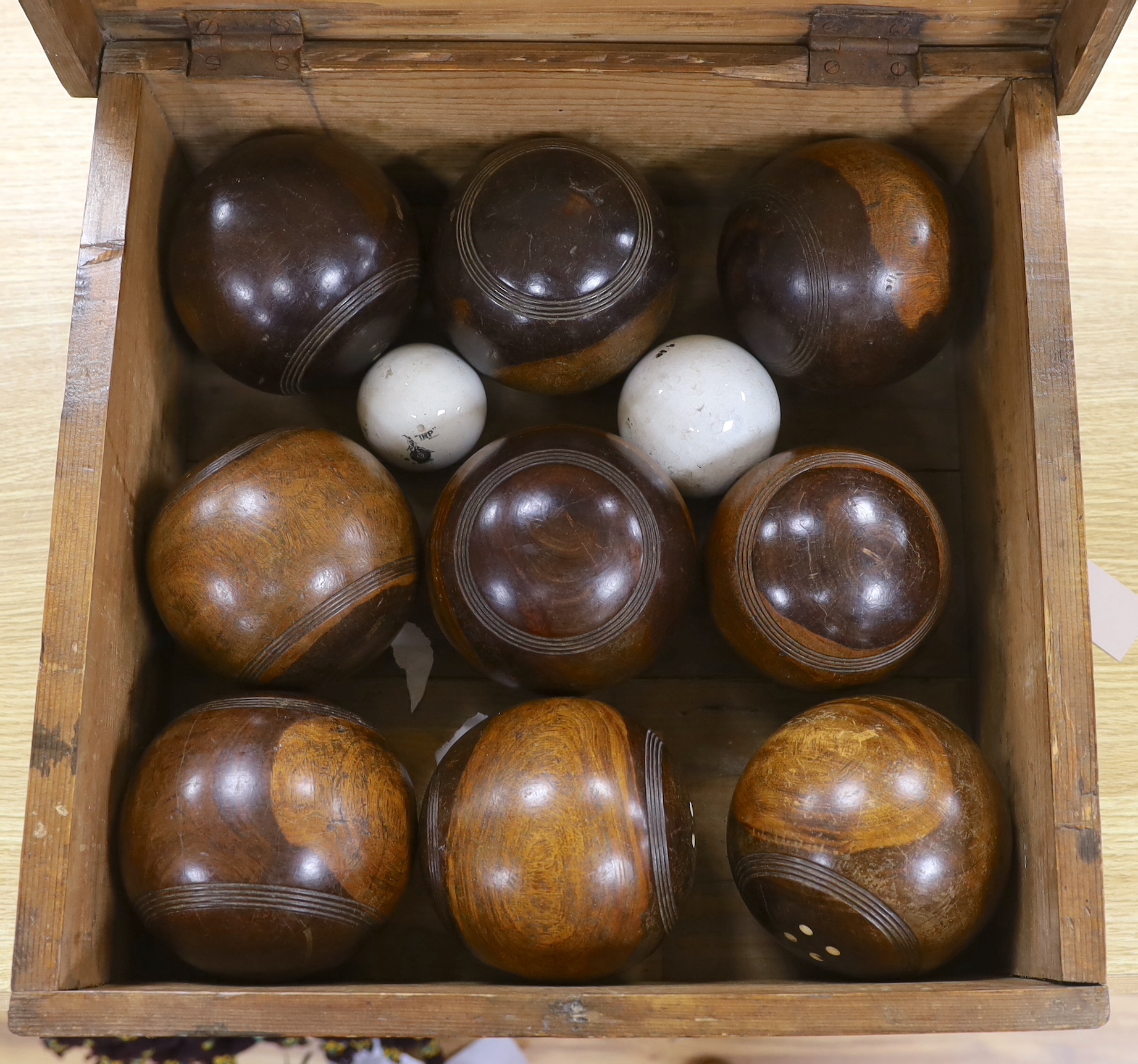 A cased Feltham & Co lignum vitae and ceramic bowls set, rules to inner lid